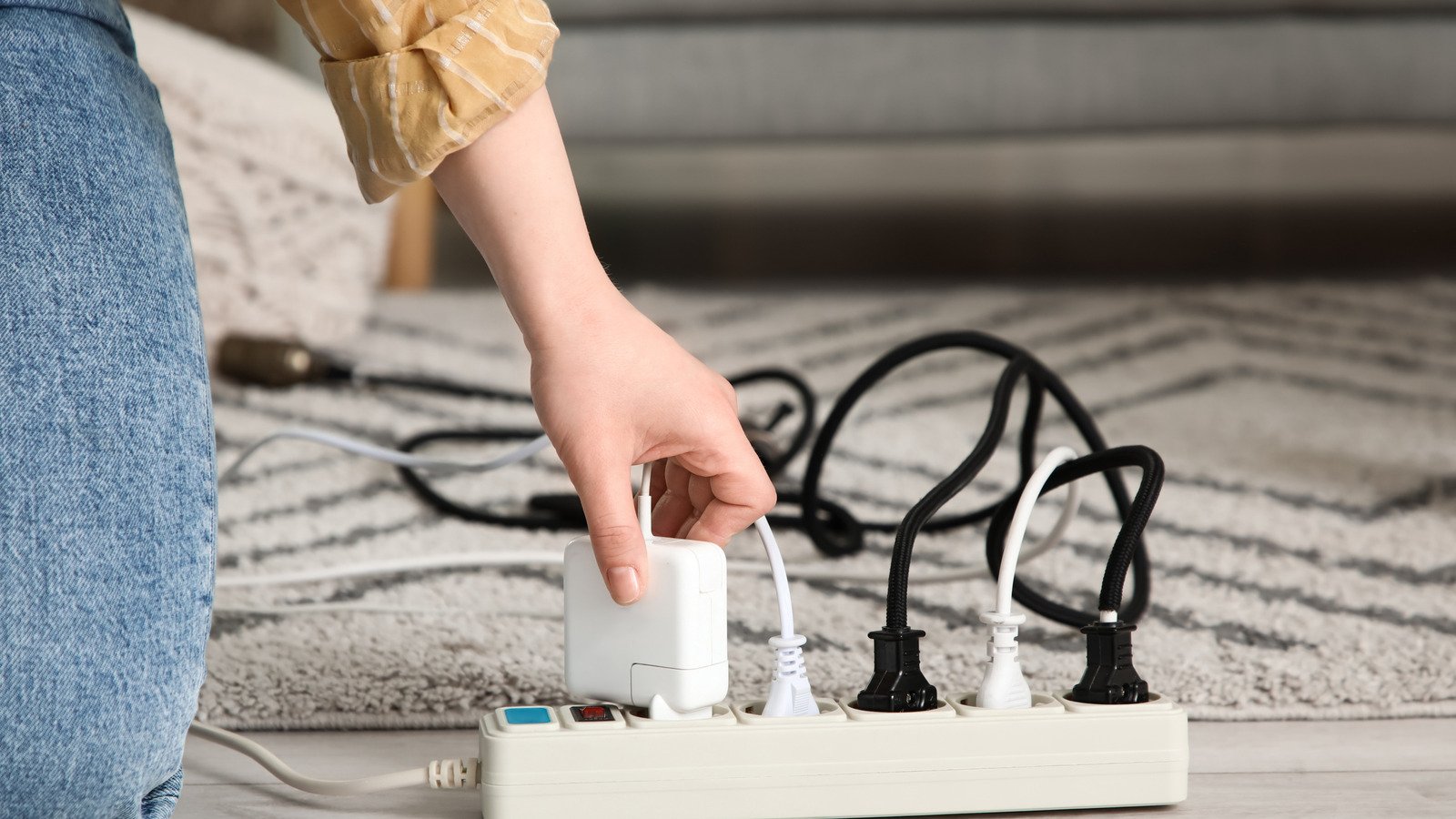 Why You Should Think Twice About Running Power Cords Under Carpets Why You Should Think Twice About Running Power Cords Under Carpets